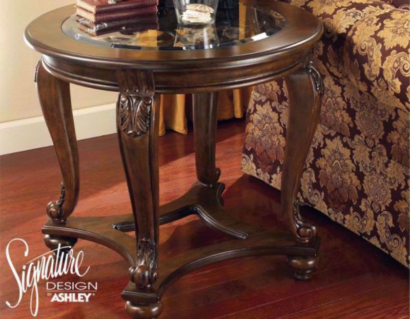Side View of the Brown Norcastle Round End Table by Ashley Furniture | Home Furniture Plus Bedding