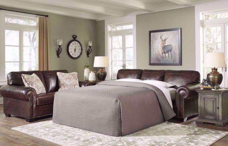 Walnut Brown Roleson Ottoman by Ashley Furniture, Slightly Angled View in a Room Setting | Home Furniture Plus Bedding