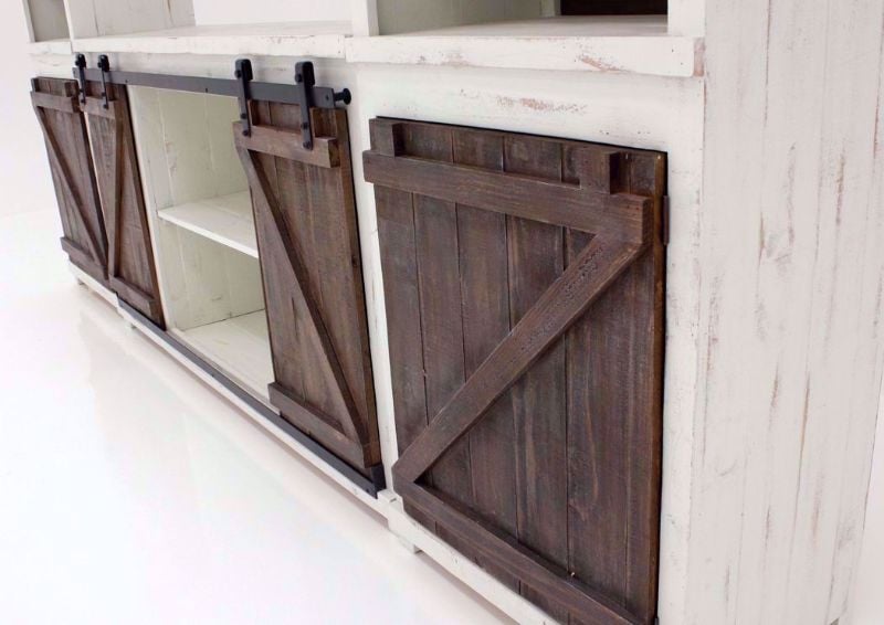 Rustic Antique White and Brown Braxton Entertainment Center at an Angle Showing Bottom Barn Style Doors and Shelves | Home Furniture Plus Bedding