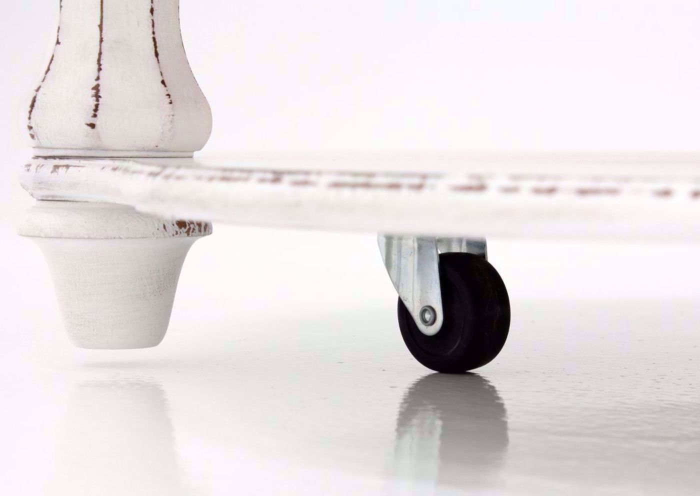 Distressed White Magnolia Manor Round Coffee Table Showing the Foot and Castor Details | Home Furniture Plus Bedding