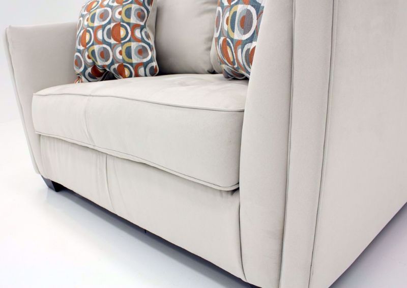 Close Up of Front Corner of the Ivory Filone Loveseat by Ashley Furniture with Accent Pillows | Home Furniture Plus Mattress
