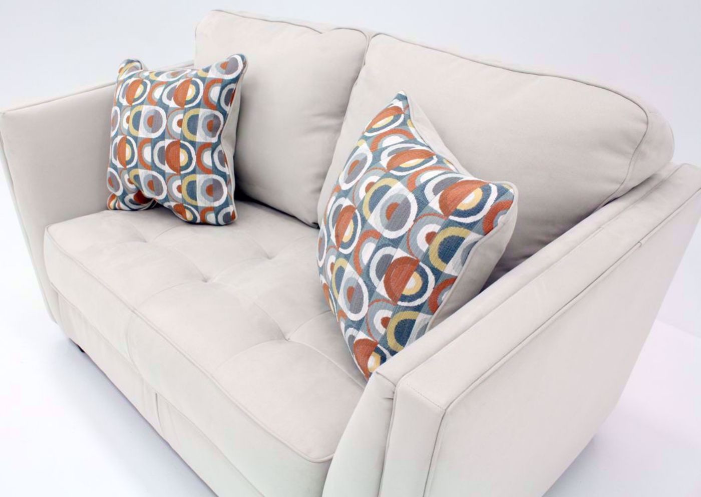 Slightly Angled View of the Ivory Filone Loveseat by Ashley Furniture with Accent Pillows | Home Furniture Plus Mattress