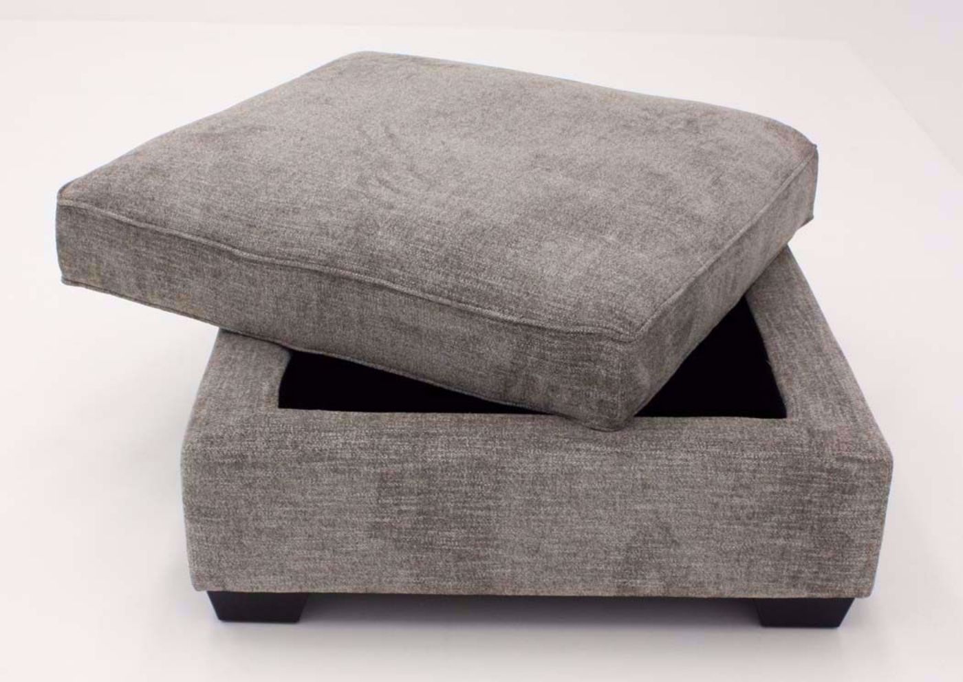 Slightly Opened Cushioned Top on the Brown Upholstered Bovarian Storage Ottoman by Ashley Furniture | Home Furniture Plus Bedding