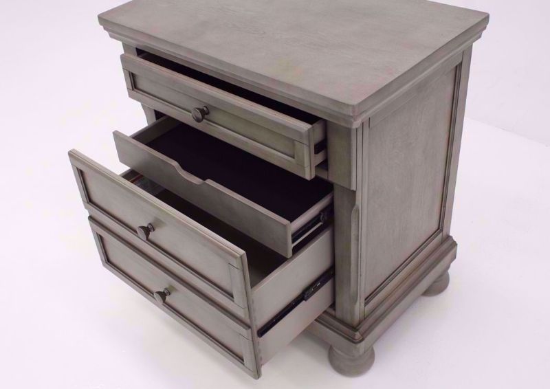 Light Gray Lettner Nightstand by Ashley Furniture at an Angle With the Drawers Open | Home Furniture Plus Mattress