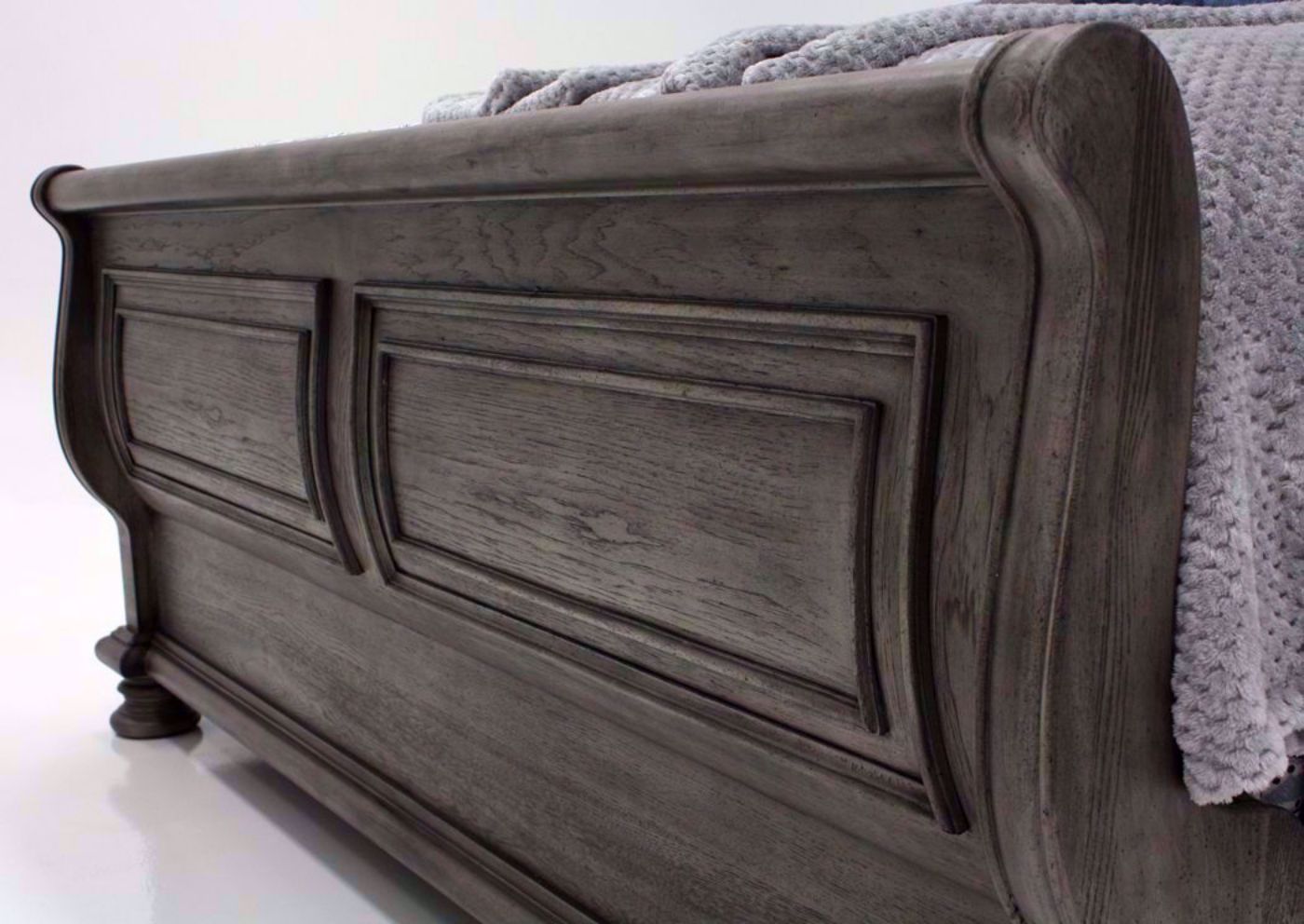 Gray Pecan Lake Way Upholstered King Size Bed Showing the Sleigh Style Footboard | Home Furniture Plus Mattress