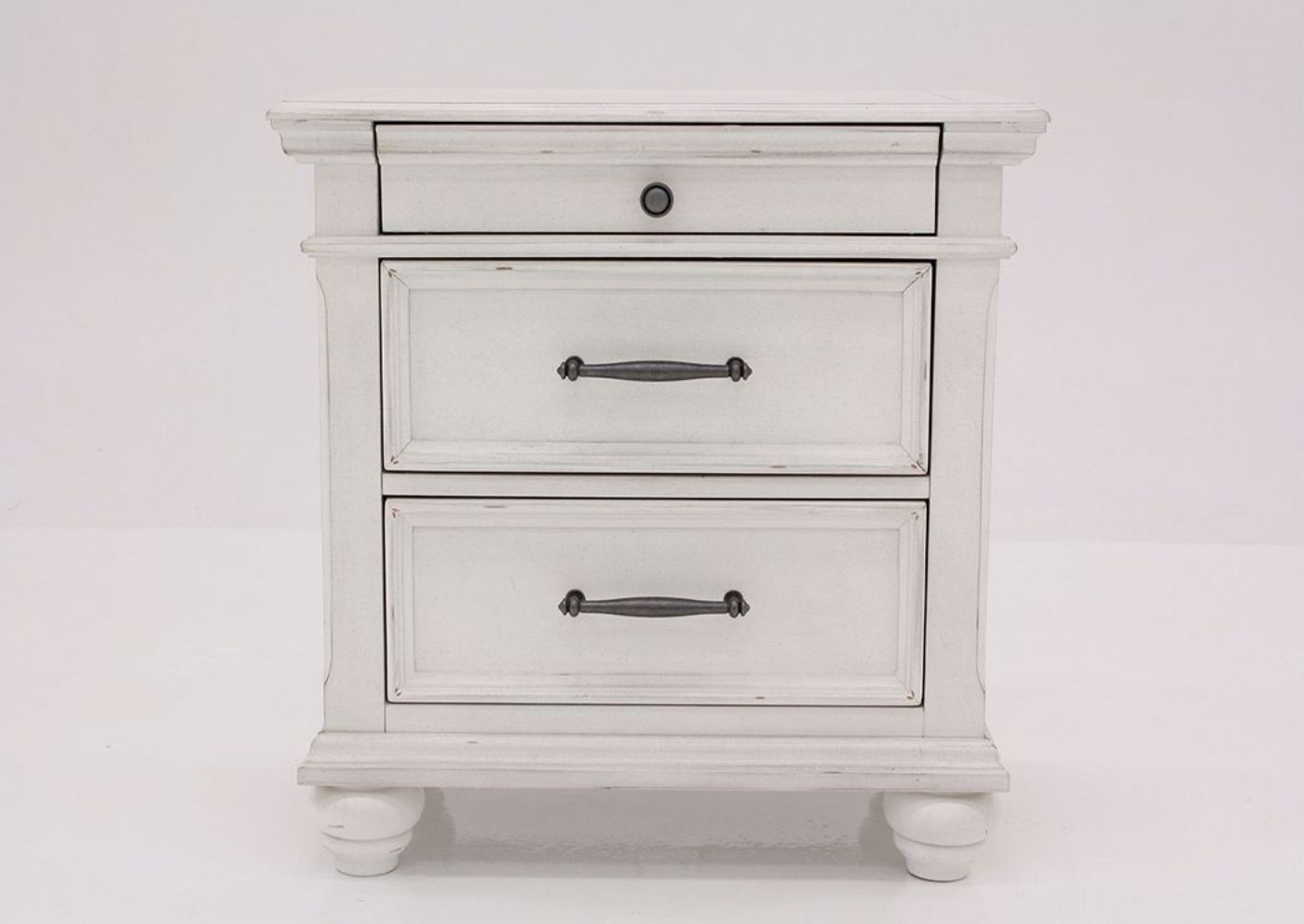 Distressed White Kanwyn 3 Drawer Nightstand by Ashley Facing Front | Home Furniture Plus Mattress