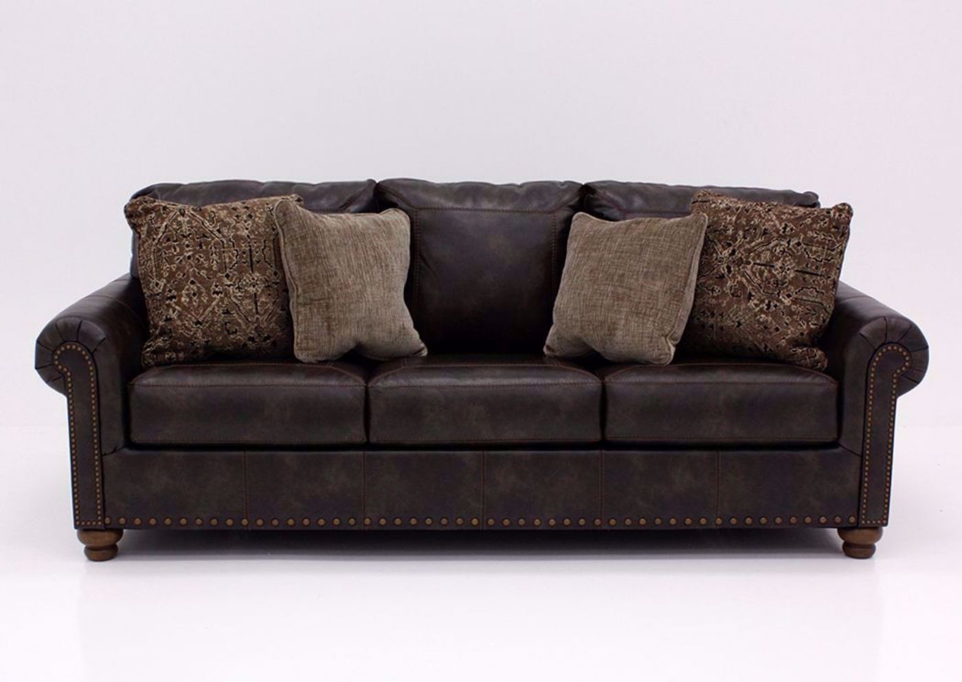 Front Facing Nicorvo Sofa by Ashley Covered in Brown Upholstery with Accent Pillows | Home Furniture Plus Bedding