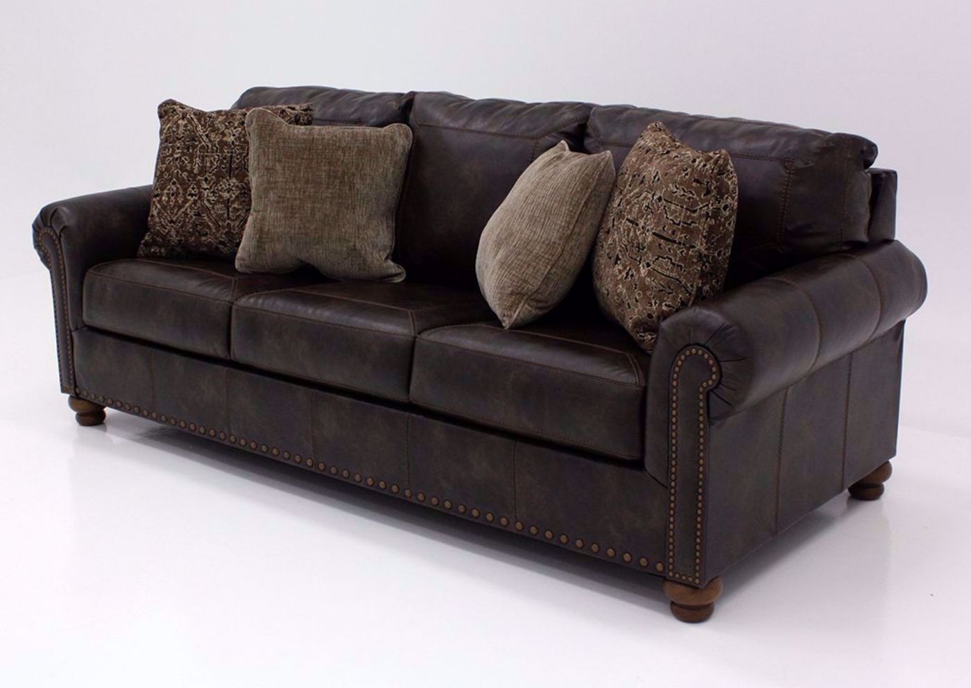 Nicorvo Sofa by Ashley Covered in Brown Upholstery with Accent Pillows | Home Furniture Plus Bedding