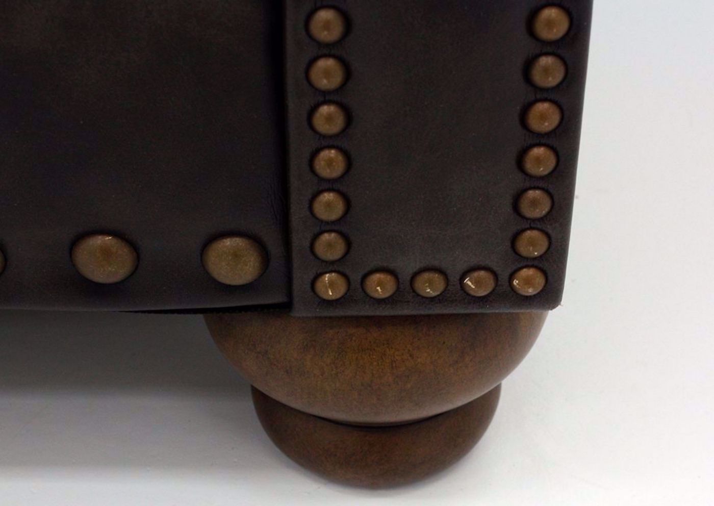 Close Up of Nailhead Accents and Bun Style Feet on Nicorvo Sofa by Ashley | Home Furniture Plus Bedding