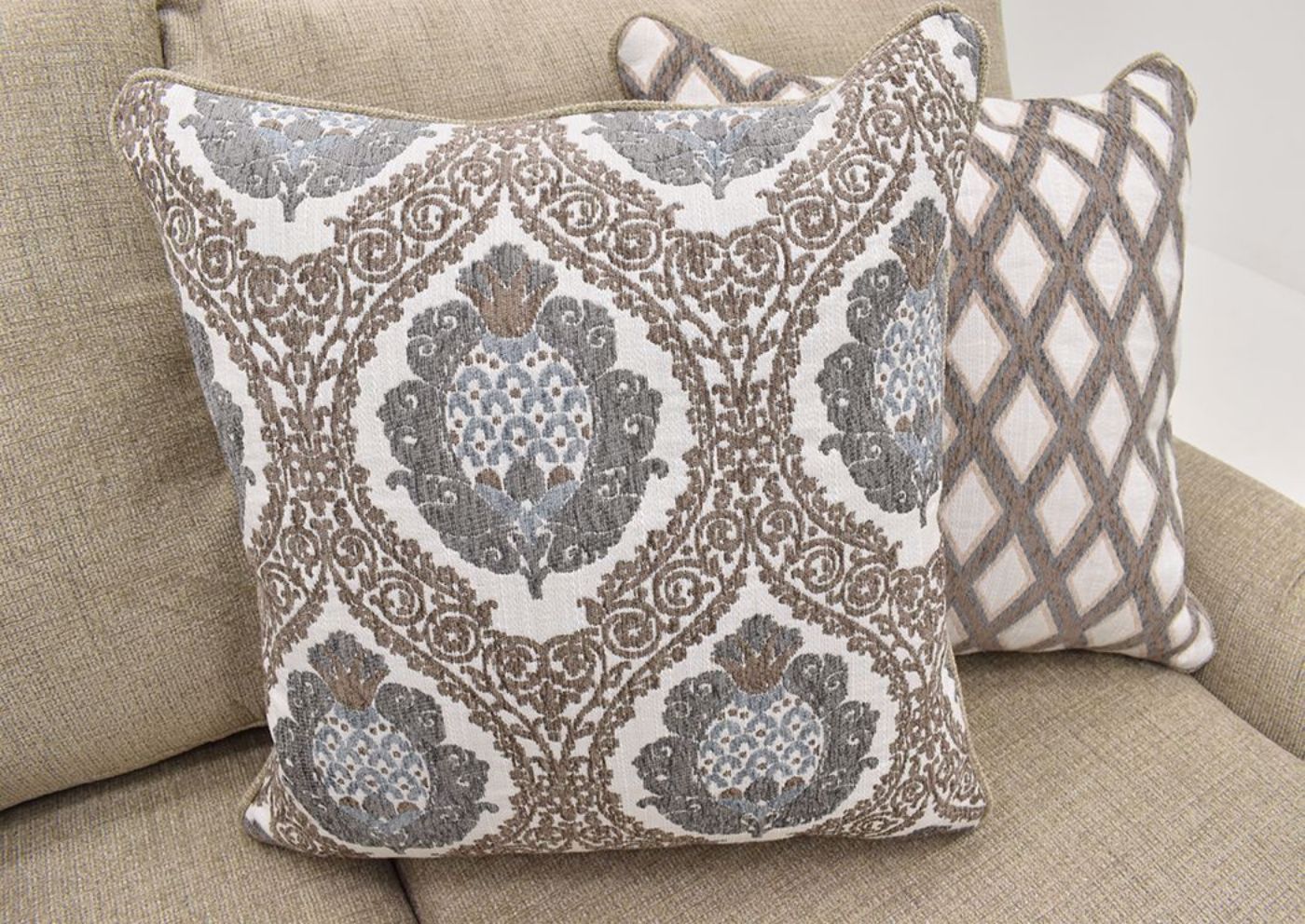 Tan Beige Archie Sofa by Albany Showing the Patterned Accent Pillow | Home Furniture Plus Mattress