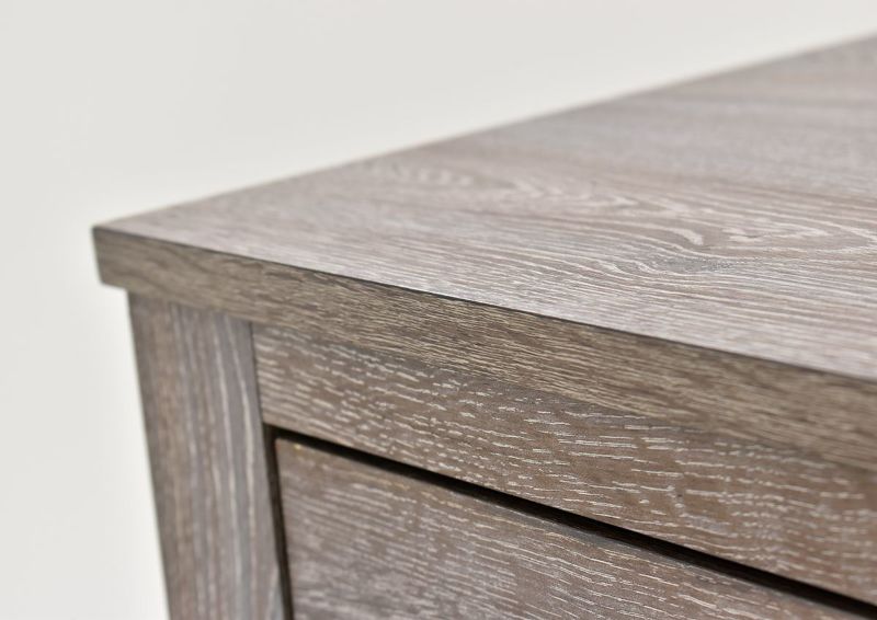Close Up of the Top Corner of the Bateson Chest of Drawers with Brown Finish and Gray Highlights | Home Furniture Plus Bedding