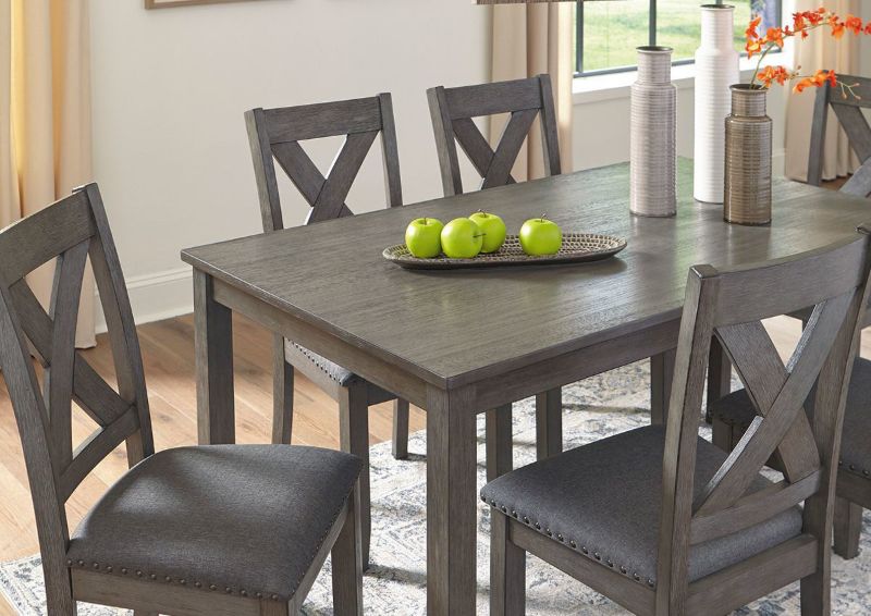 Gray Caitbrook 7 Piece Dining Set by Ashley Furniture Showing a Mood View | Home Furniture Plus Bedding
