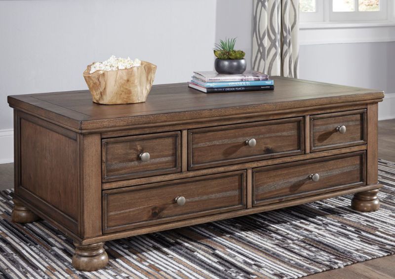 Chestnut Brown Flynnter Coffee Table by Ashley Furniture in a Room Setting | Home Furniture Plus Mattress