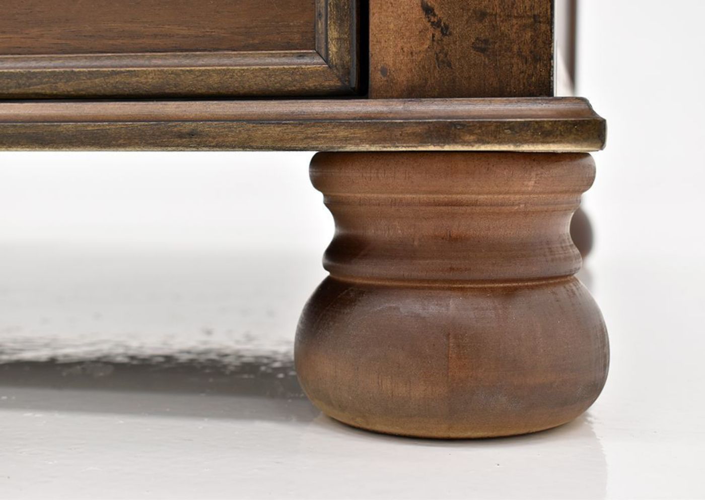 Chestnut Brown Flynnter Coffee Table by Ashley Furniture Showing the Bun Style Foot Detail | Home Furniture Plus Mattress