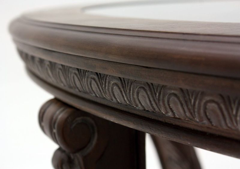 Brown Charmond Oval Coffee Table by Ashley Furniture Showing the Table Edge Carving Detail | Home Furniture Plus Mattress