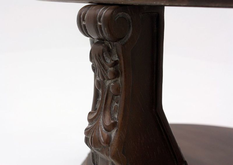 Brown Charmond Oval Coffee Table by Ashley Furniture Showing the Leg Carving Detail | Home Furniture Plus Mattress