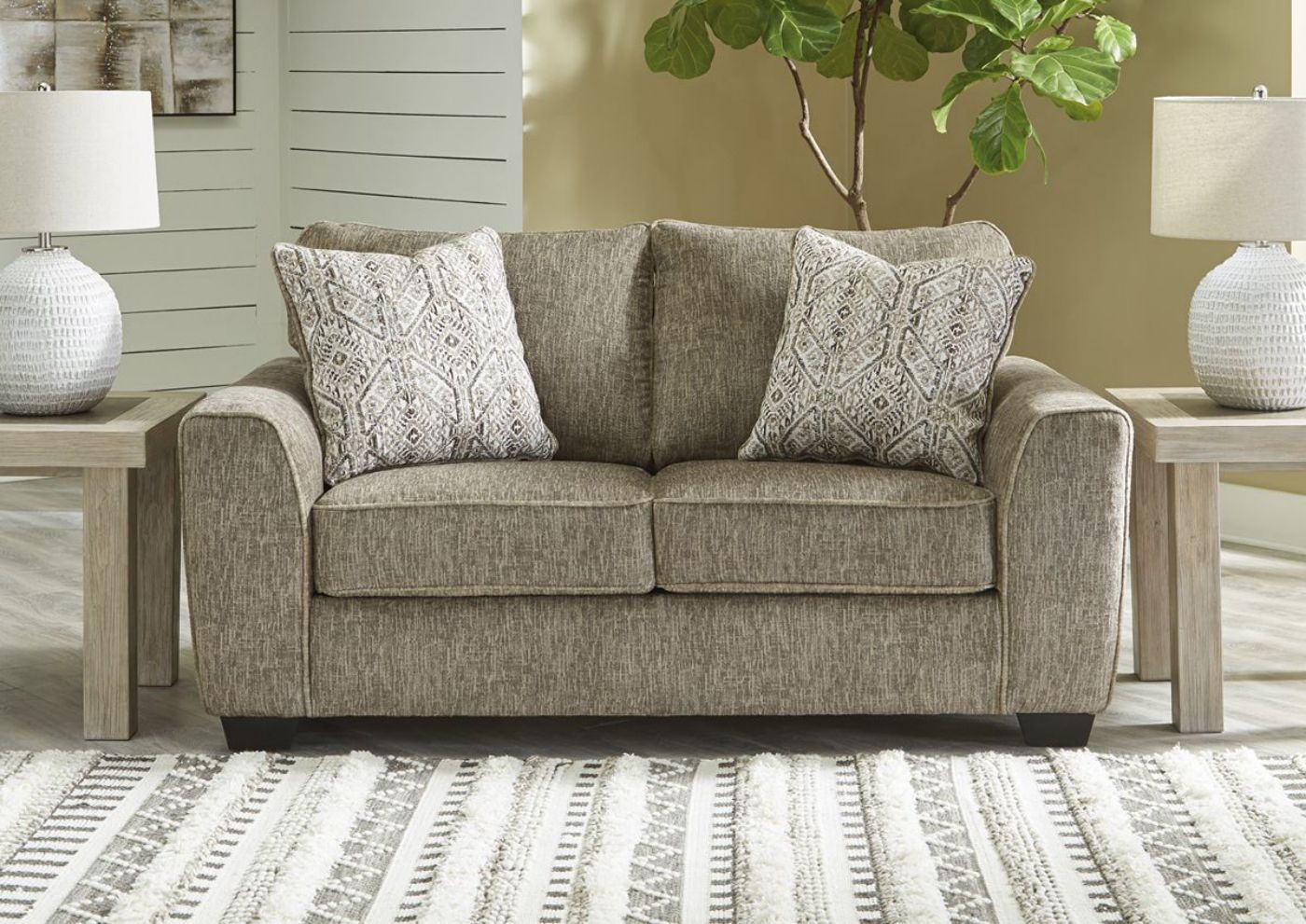 Angled View of the Chocolate Brown Olin Loveseat by Ashley Furniture in A Room View | Home Furniture Plus Bedding