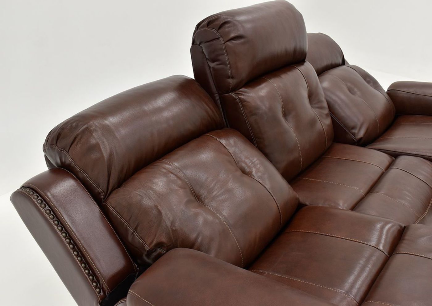 Angled Close Up View of the Reclined Rosewood Leather Reclining Sofa in Warm Brown by Behold Home showing seat back cushions | Home Furniture Plus Bedding