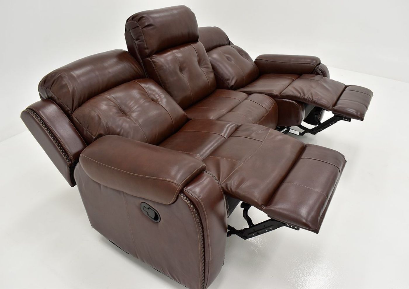 Angled Close Up View of the Reclined Rosewood Leather Reclining Sofa in Warm Brown by Behold Home | Home Furniture Plus Bedding
