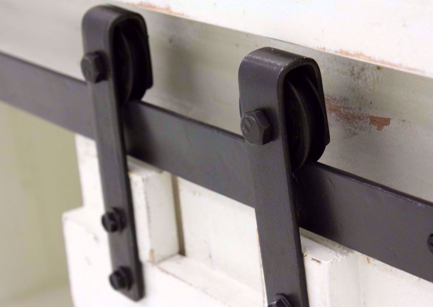 Close Up View of the Sliding Barn Door Hardware on the Diego 50” TV Stand in White by Vintage Furniture | Home Furniture Plus Bedding