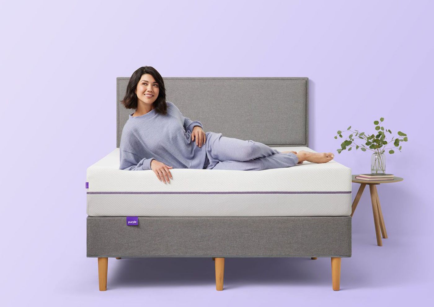 Woman Lounging on the Purple® Hybrid 2 Mattress by Purple® Innovation LLC | Home Furniture Plus Bedding