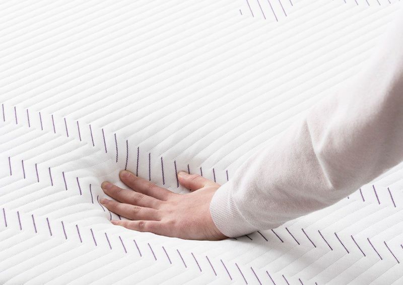Hands Testing the Feel on the Purple Grid on  the Purple® Hybrid Premier 3 Mattress by Purple® Innovation LLC | Home Furniture Plus Bedding