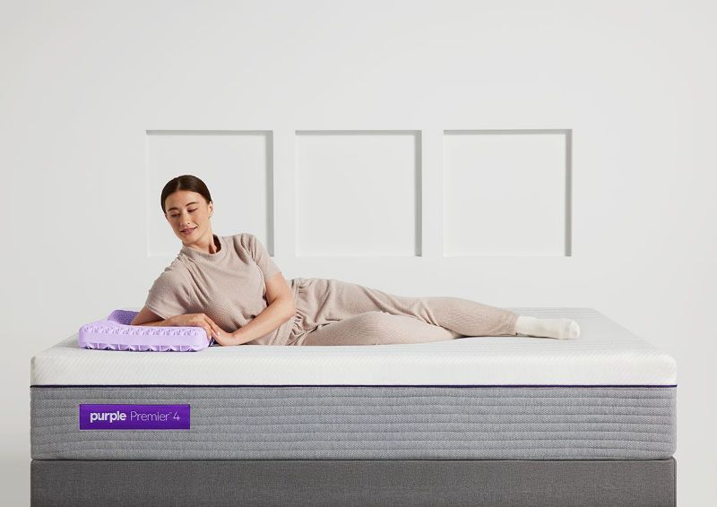 Woman Lounging on the Purple® Hybrid Premier 4 Mattress by Purple® Innovation LLC | Home Furniture Plus Bedding