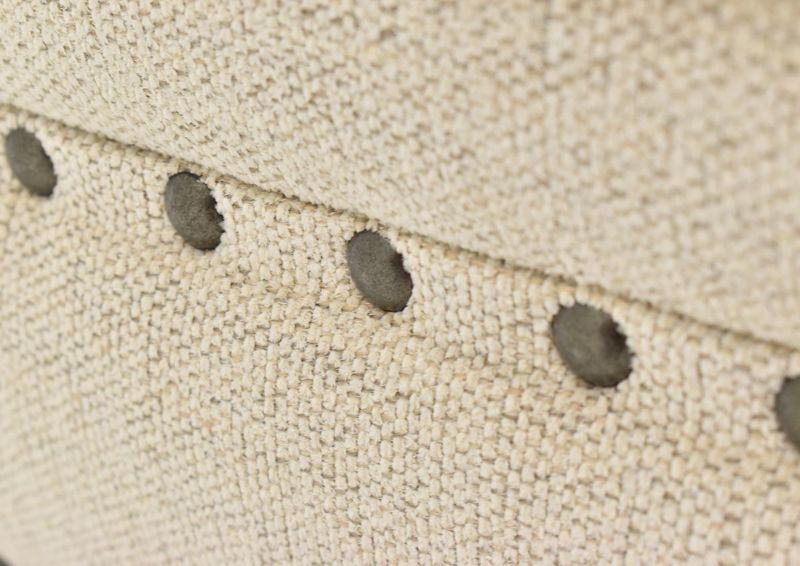 Close Up View of the Nailhead Trim on the Everette Ottoman in Off-White by Klaussner | Home Furniture Plus Bedding