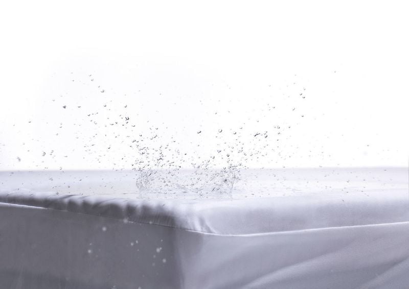 View of Water Splashing against the Deep Pocket Mattress Protector in King by Purple® | Home Furniture Plus Bedding