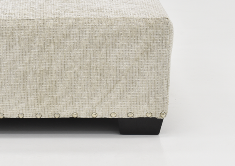 Corner View with Nailhead Accent Trim on the Sycamore Ottoman in Sandstone by Behold Home | Home Furniture Plus Bedding