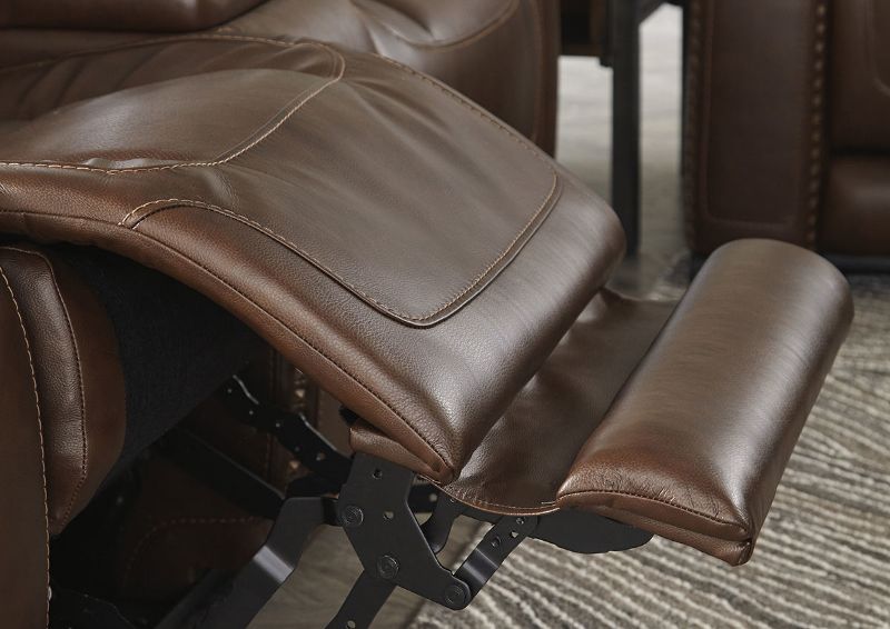 Close Up View of the Extended Footrest on the Man-Den Power Reclining Loveseat in Mahogany Brown by Ashley Furniture | Home Furniture Plus Bedding