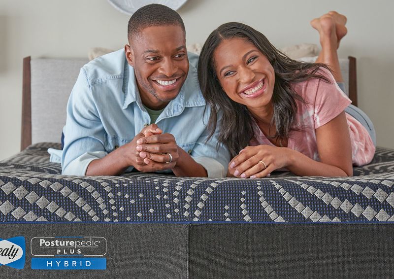 Lifestyle View of a Man and Woman on the Sealy Albany Medium Hybrid Mattress | Home Furniture Plus Bedding
