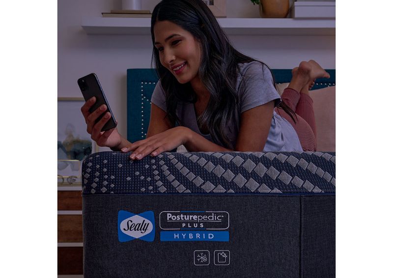 Lifestyle View of a Woman on the Brenham Firm Hybrid Mattress by Sealy | Home Furniture Plus Bedding
