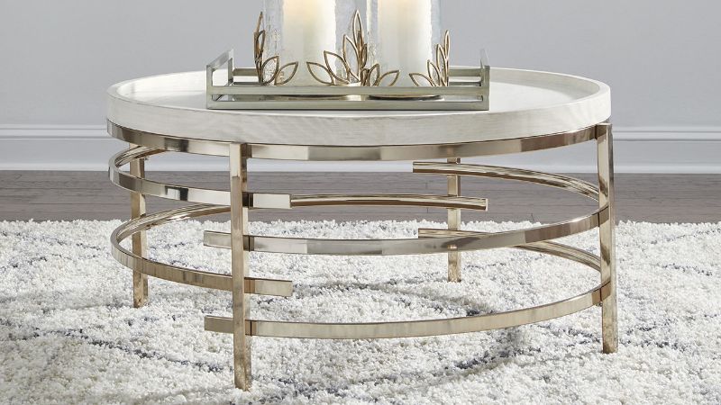 Room View of the Montiflyn Coffee Table in Off-White and Gold by Ashley Furniture | Home Furniture Plus Bedding