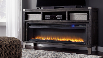 Room View of the Todoe TV Stand Console Table with Fireplace Insert in Gray by Ashley Furniture | Home Furniture Plus Bedding Room View of the Todoe TV Stand Console Table with Fireplace Insert in Gray by Ashley Furniture | Home Furniture Plus Bedding