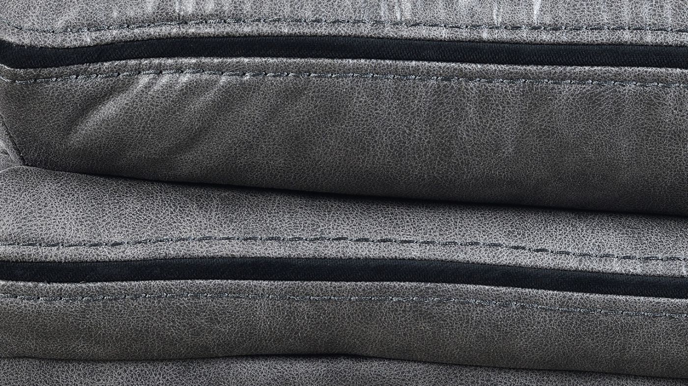 Close Up View of the Stitching on the Linville Glider Recliner in Gray by New Classic | Home Furniture Plus Bedding