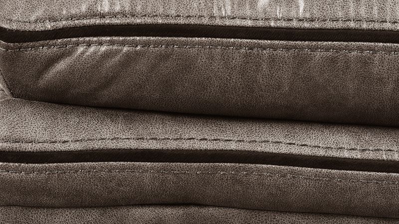 Close Up View of the Stitching on the Linville Glider Recliner in Brown by New Classic | Home Furniture Plus Bedding