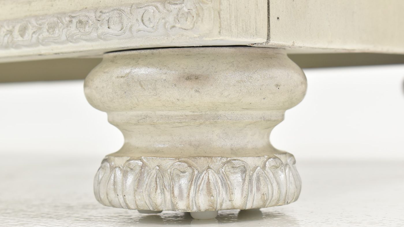 View of the Carved Foot on the Ava Chest of Drawers in White by Avalon Furniture | Home Furniture Plus Bedding