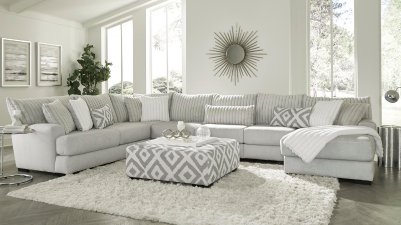 Tweed Sectional Sofa with Light Gray Upholstery and Accent Pillows in Room Setting, Ottoman shown is sold separately | Home Furniture Plus Bedding